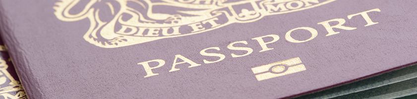 A Close Up Shot Of Two United Kingdom Biometric Passports On A Road Map Taken In A Studio